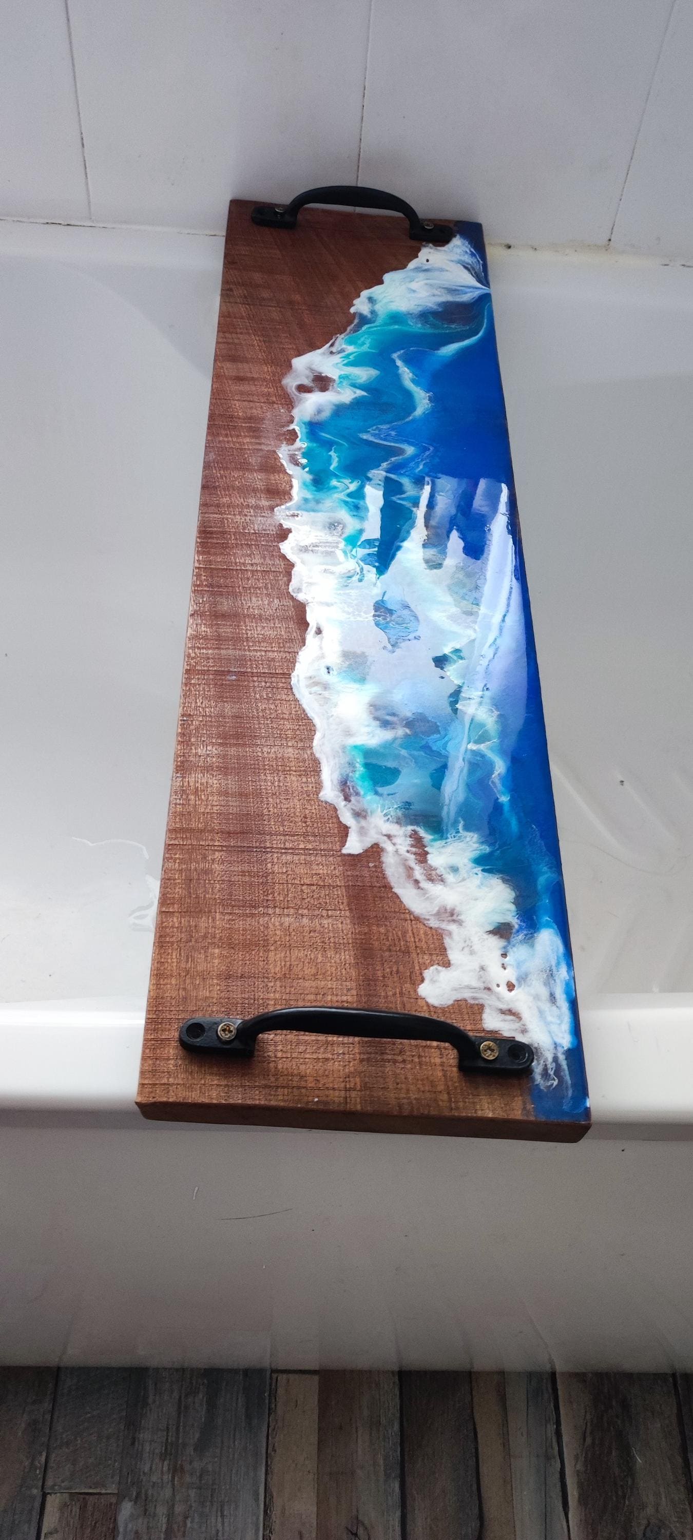 Sapele wood bath tray with resin ocean waves