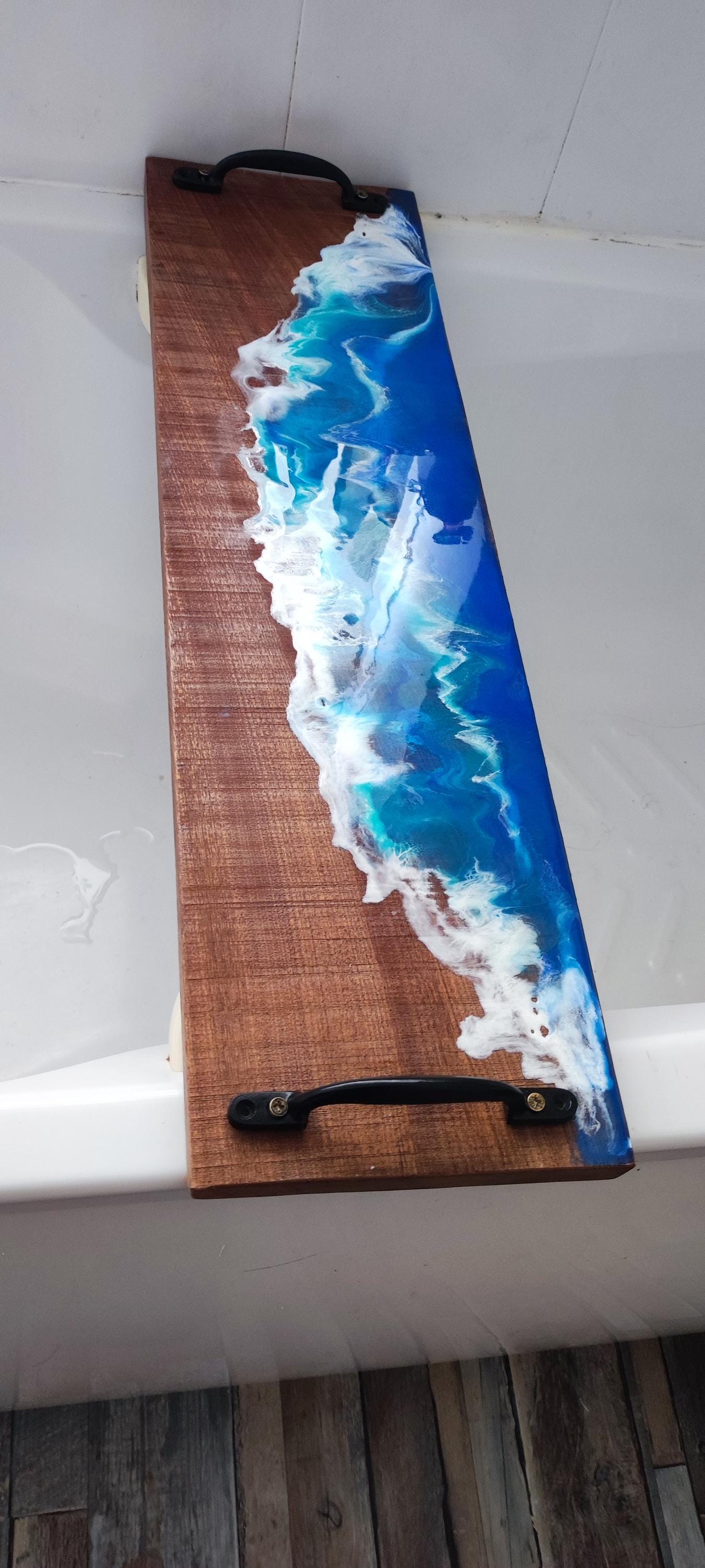 Sapele wood bath tray with resin ocean waves