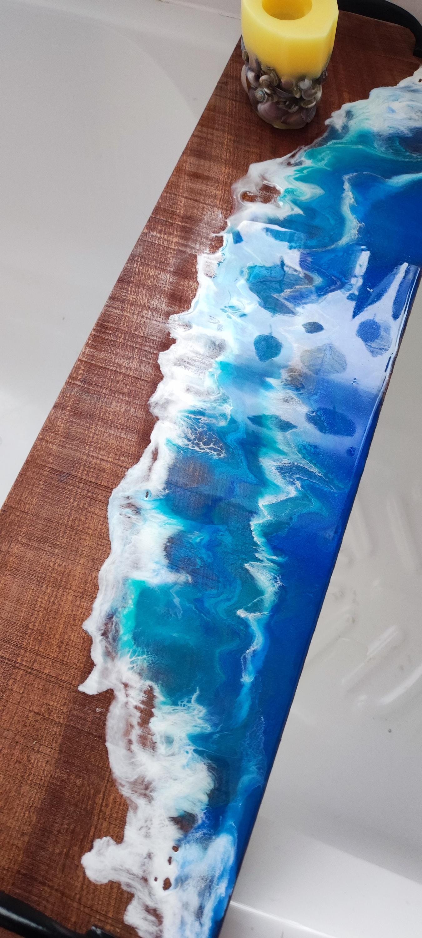 Sapele wood bath tray with resin ocean waves